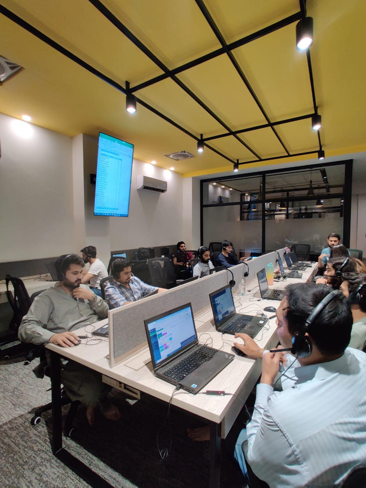 Team reviewing a live reporting dashboard on a large screen