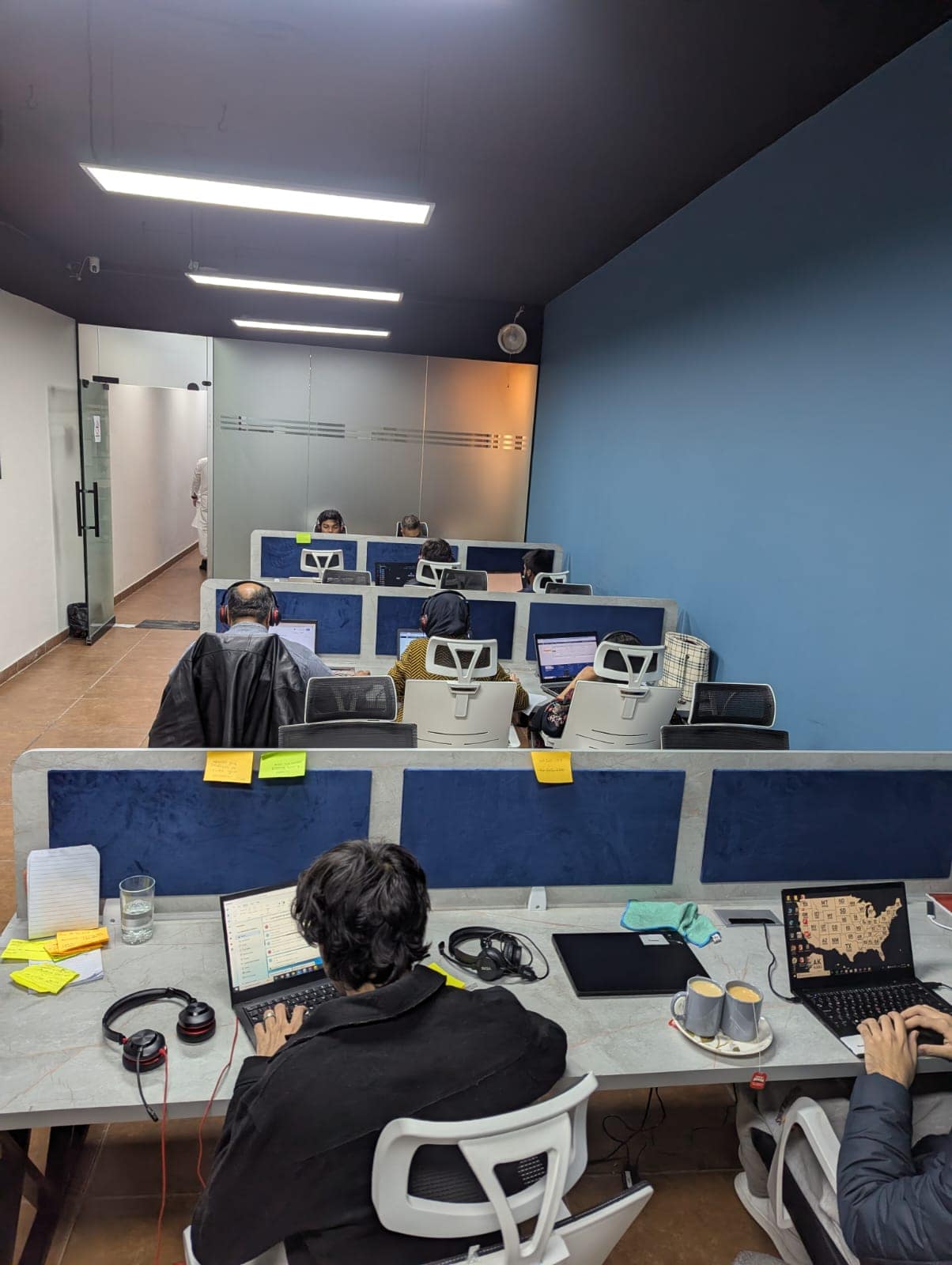 Close-up of an agent's desk with headset and laptop