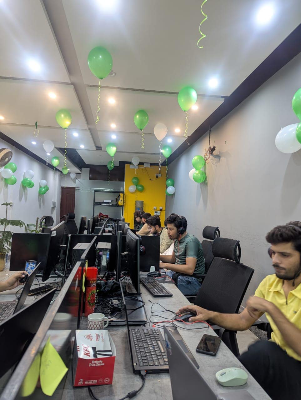 The office floor decorated with green and white balloons