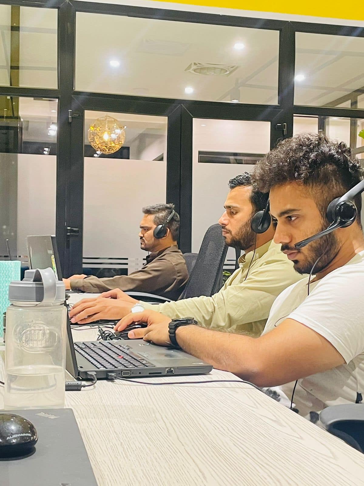 Team members focused on their laptops during a support shift